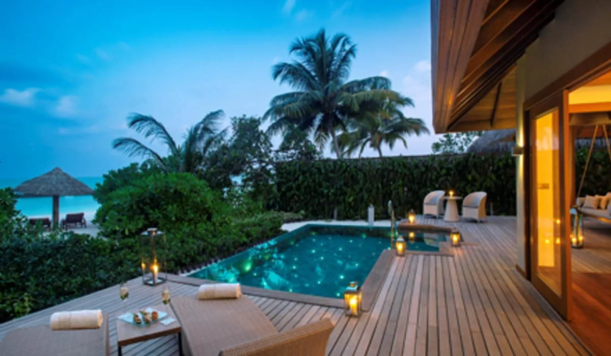 Villa deck with a private pool and tropical garden at dusk