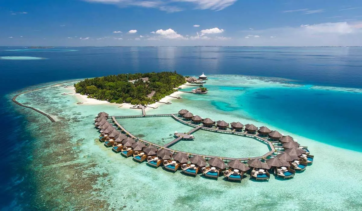 Aerial view of Baros island and its curving row of water villas