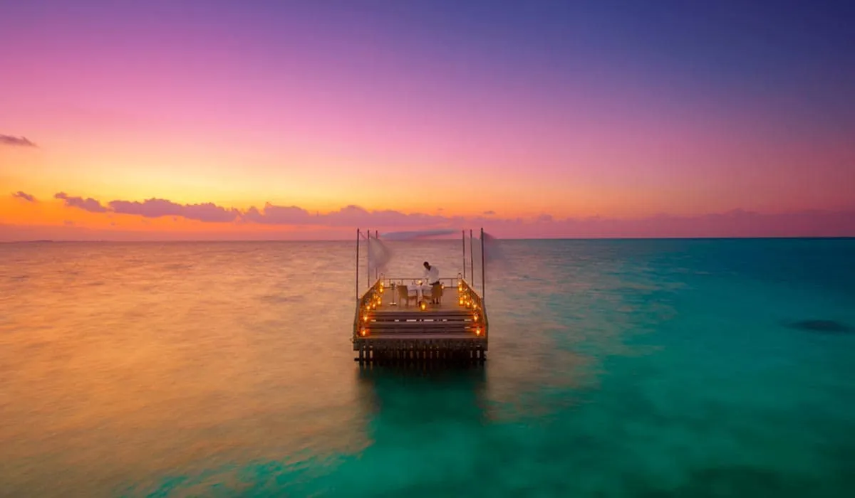 The Piano Deck lit up in the lagoon at sunset