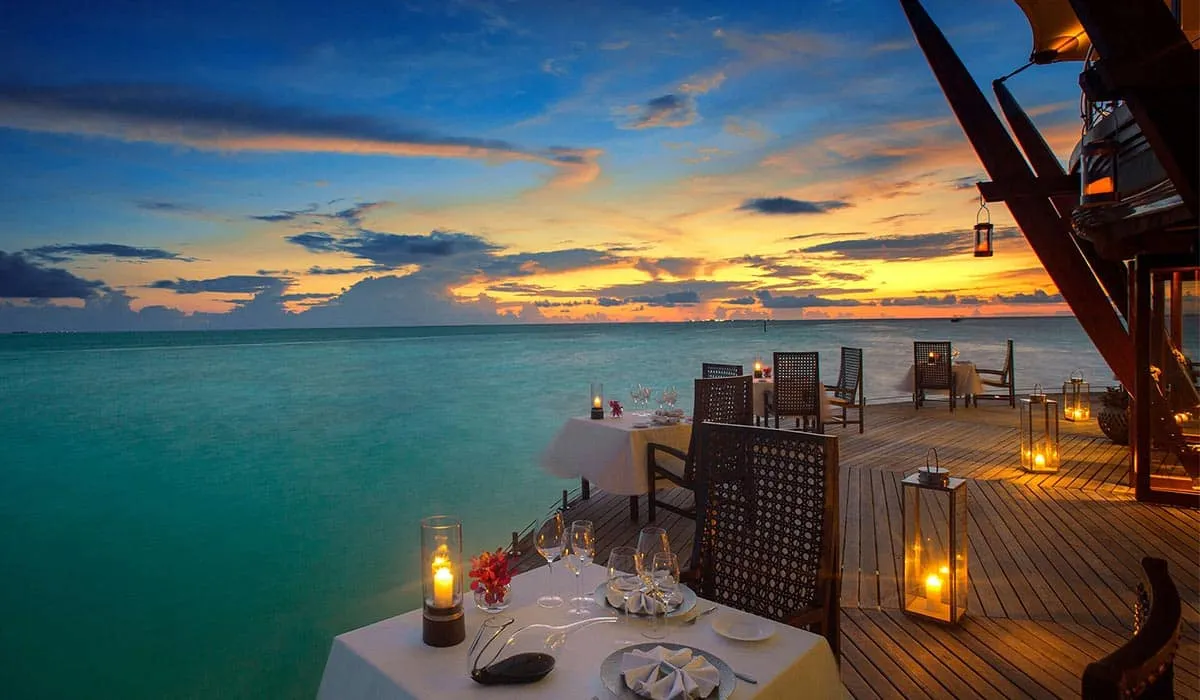 Candlelit tables on the Lighthouse restaurant deck at sunset