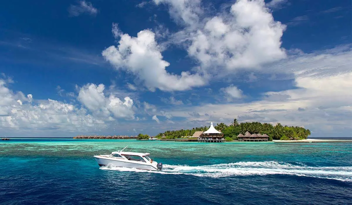 Speedboat racing across turquoise water towards Baros island