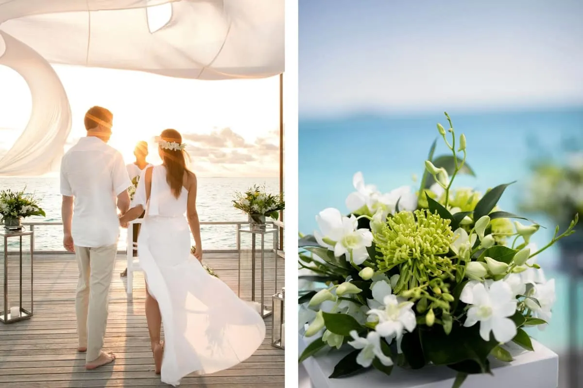Bride and groom walking along a sunlit deck, beside a white and green floral arrangement