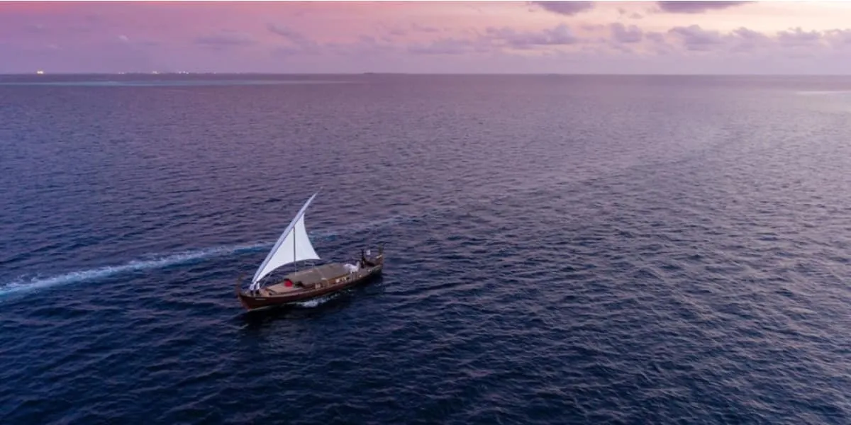 Aerial view of a sailing dhoni on the open sea at dusk