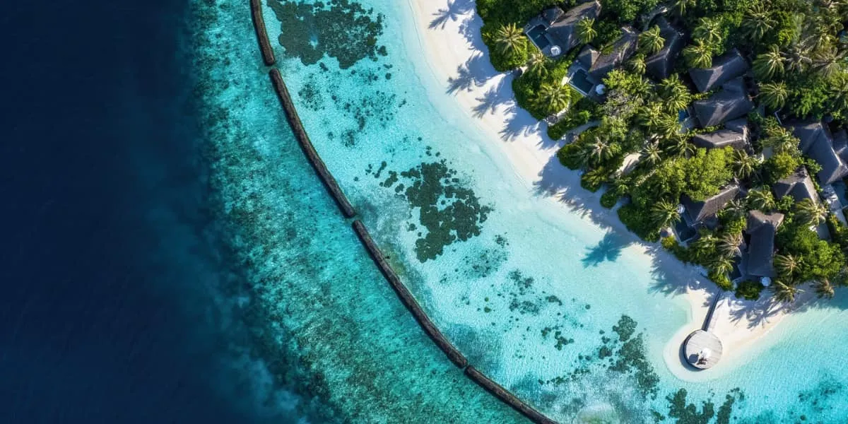 Aerial view of the beach, lagoon and reef edge at Baros