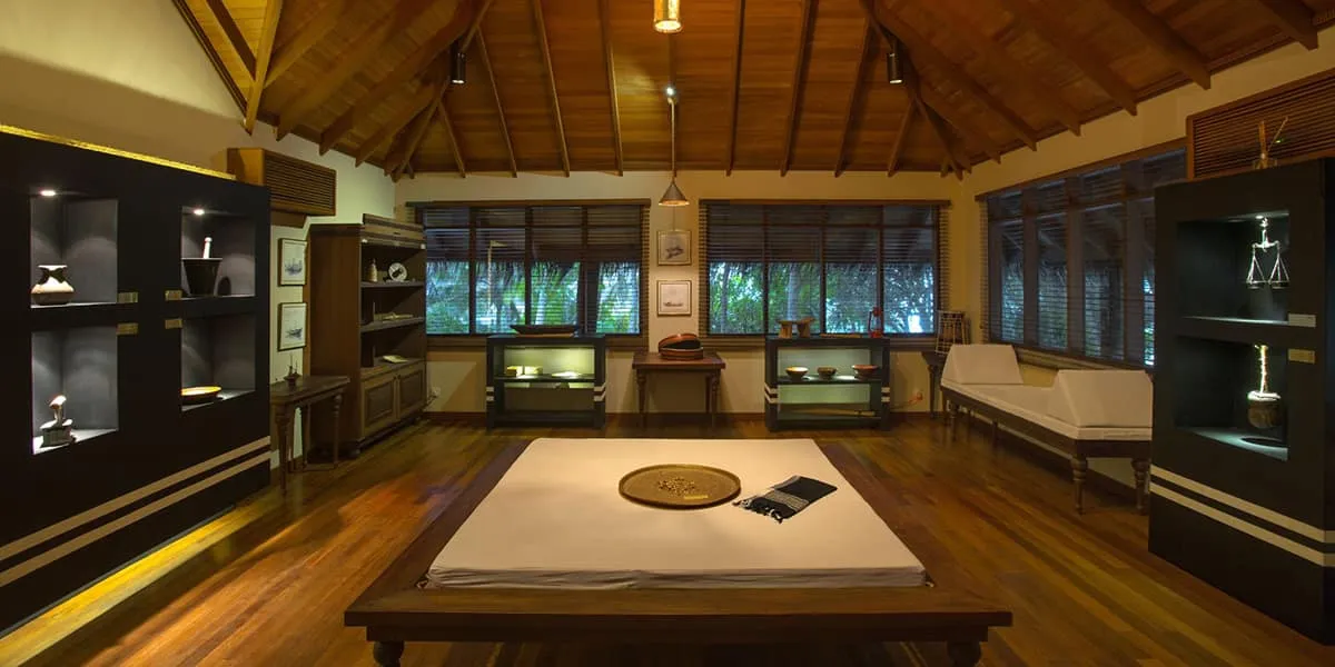 Spa room with wooden floor, a low treatment mat and dark wooden cabinets