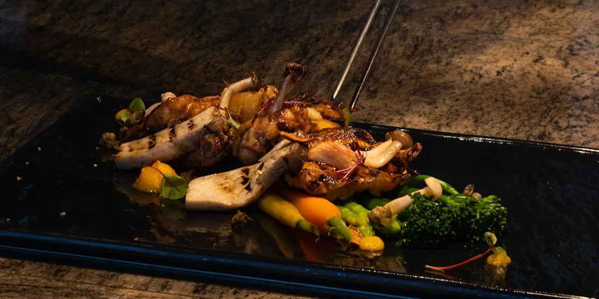 Grilled seafood and vegetables served on a black slate platter