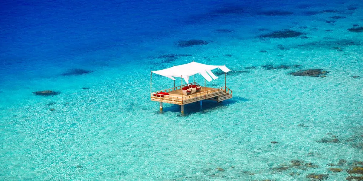 Canopied piano deck standing in a clear turquoise lagoon