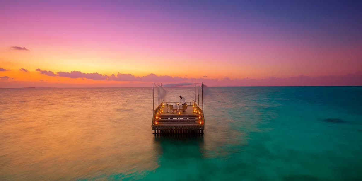 Candlelit piano deck in the lagoon at sunset
