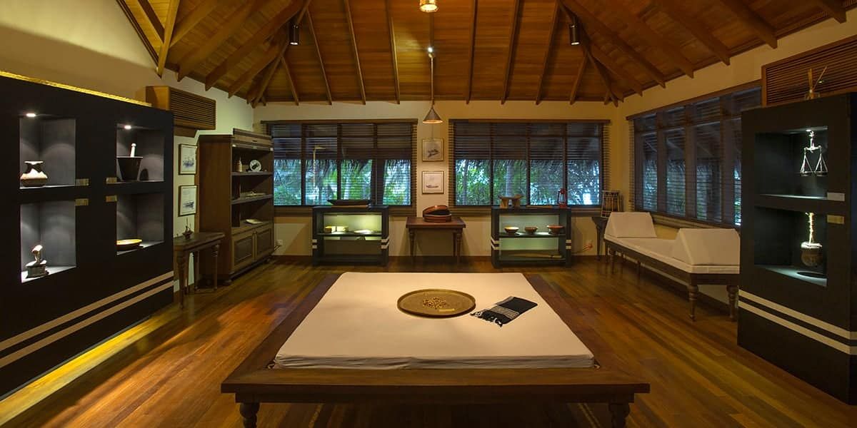 Lounge with wooden display cabinets and a low day bed