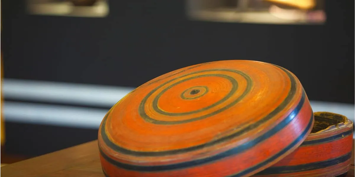 Close-up of a traditional lacquered box striped in orange, red and black