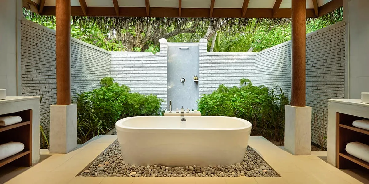 Open-air bathroom with a freestanding bathtub and garden shower