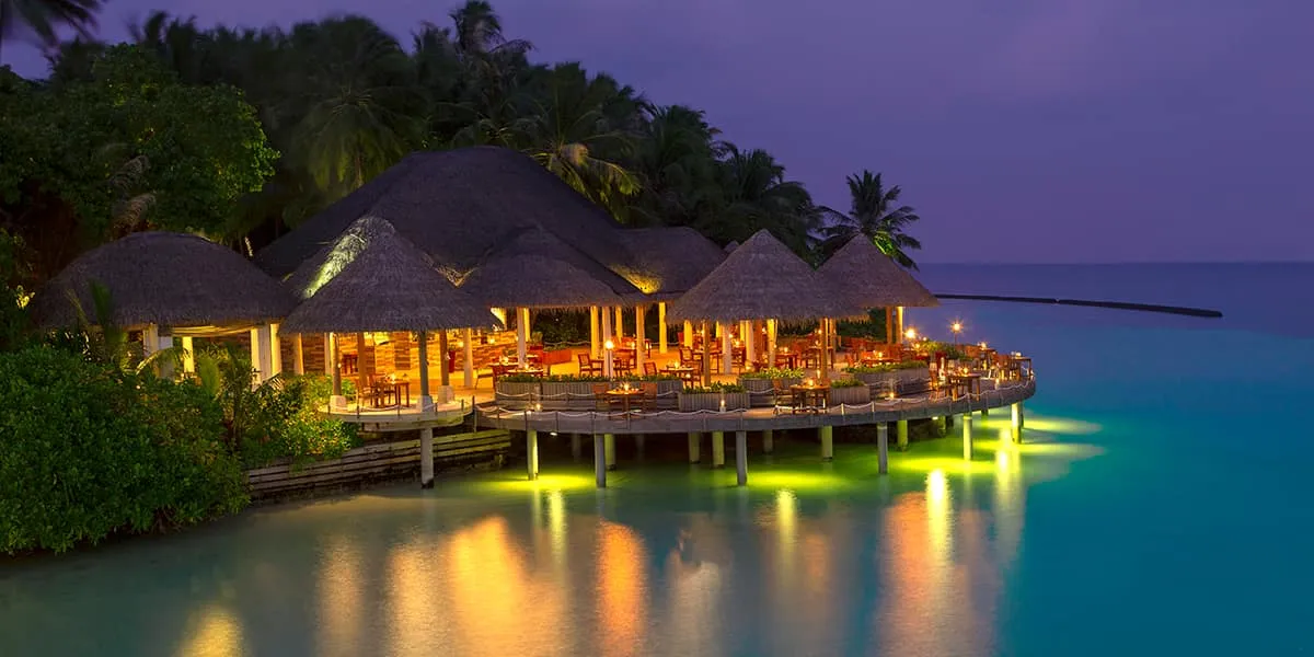 Cayenne Grill lit up over the water at dusk