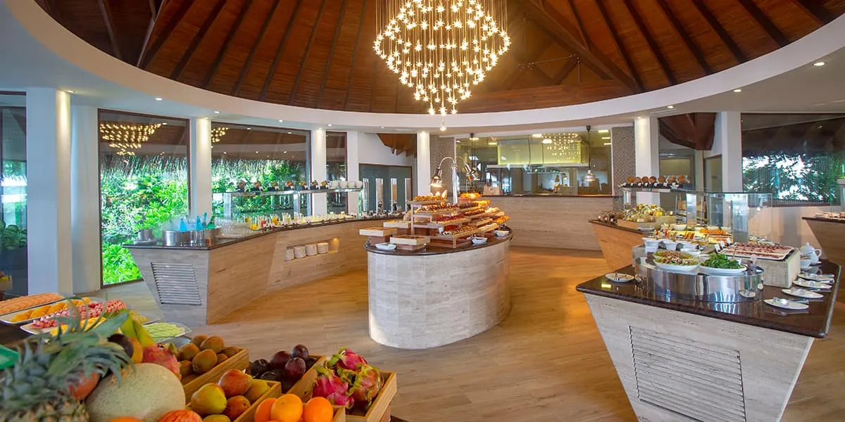 Breakfast buffet stations beneath a chandelier at Lime restaurant