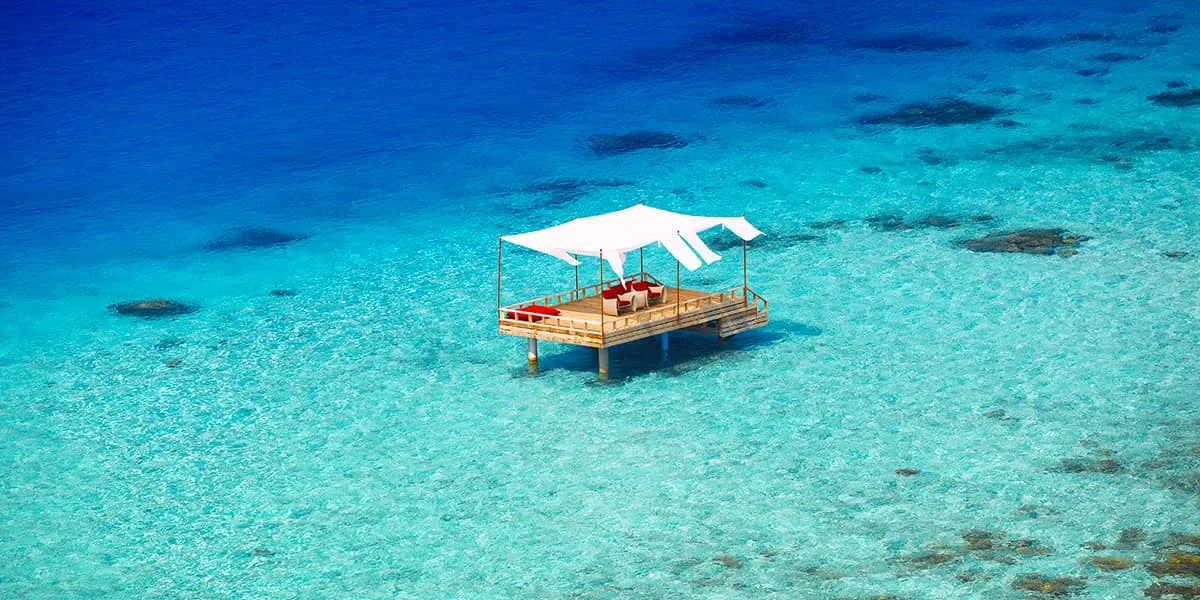 Canopied piano deck standing in a clear turquoise lagoon