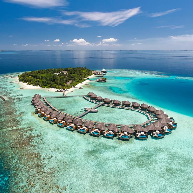 Aerial view of Baros Maldives with its water villas and lagoon