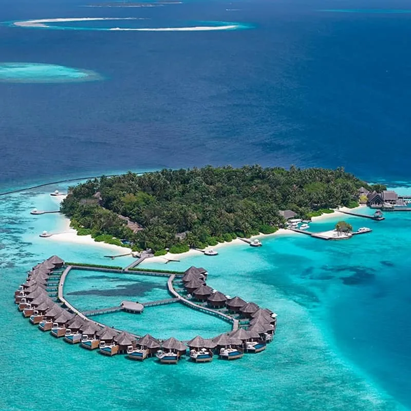 Aerial view of Baros island, its water villas and turquoise lagoon