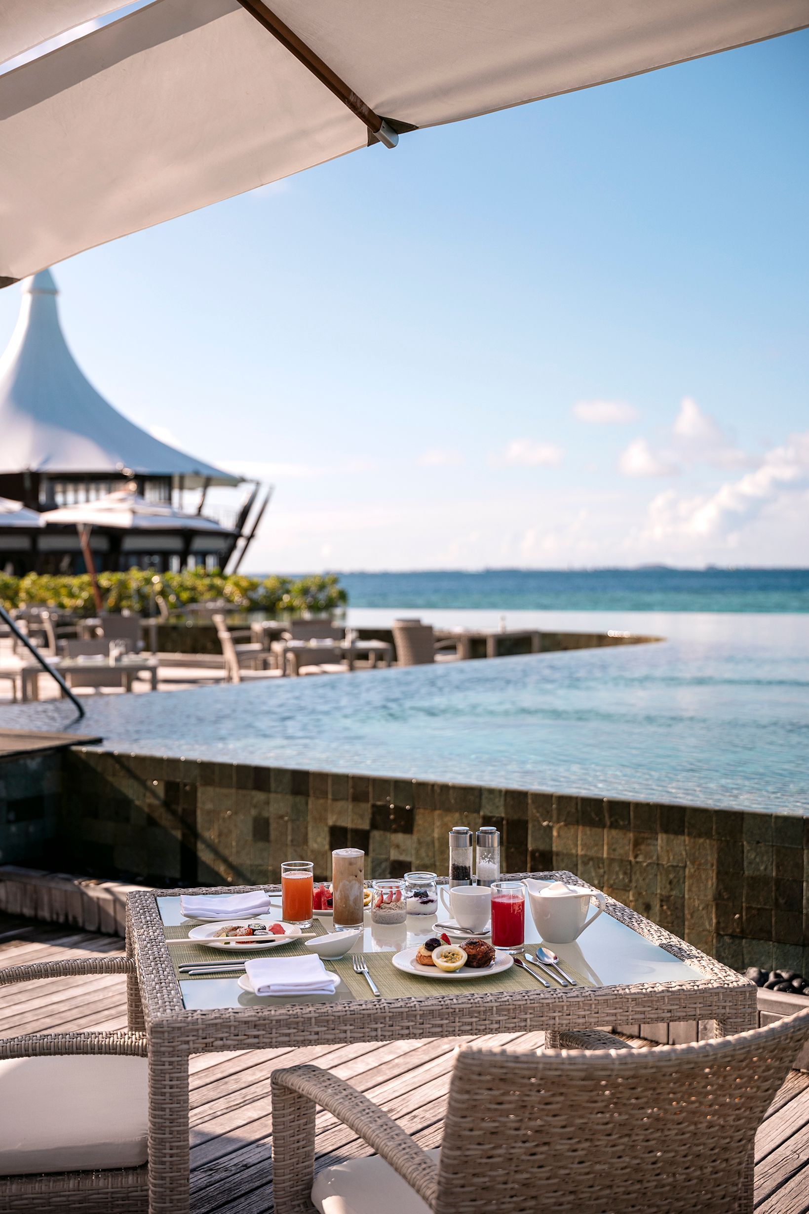 Breakfast laid out on the deck at Lime restaurant beside the infinity edge pool