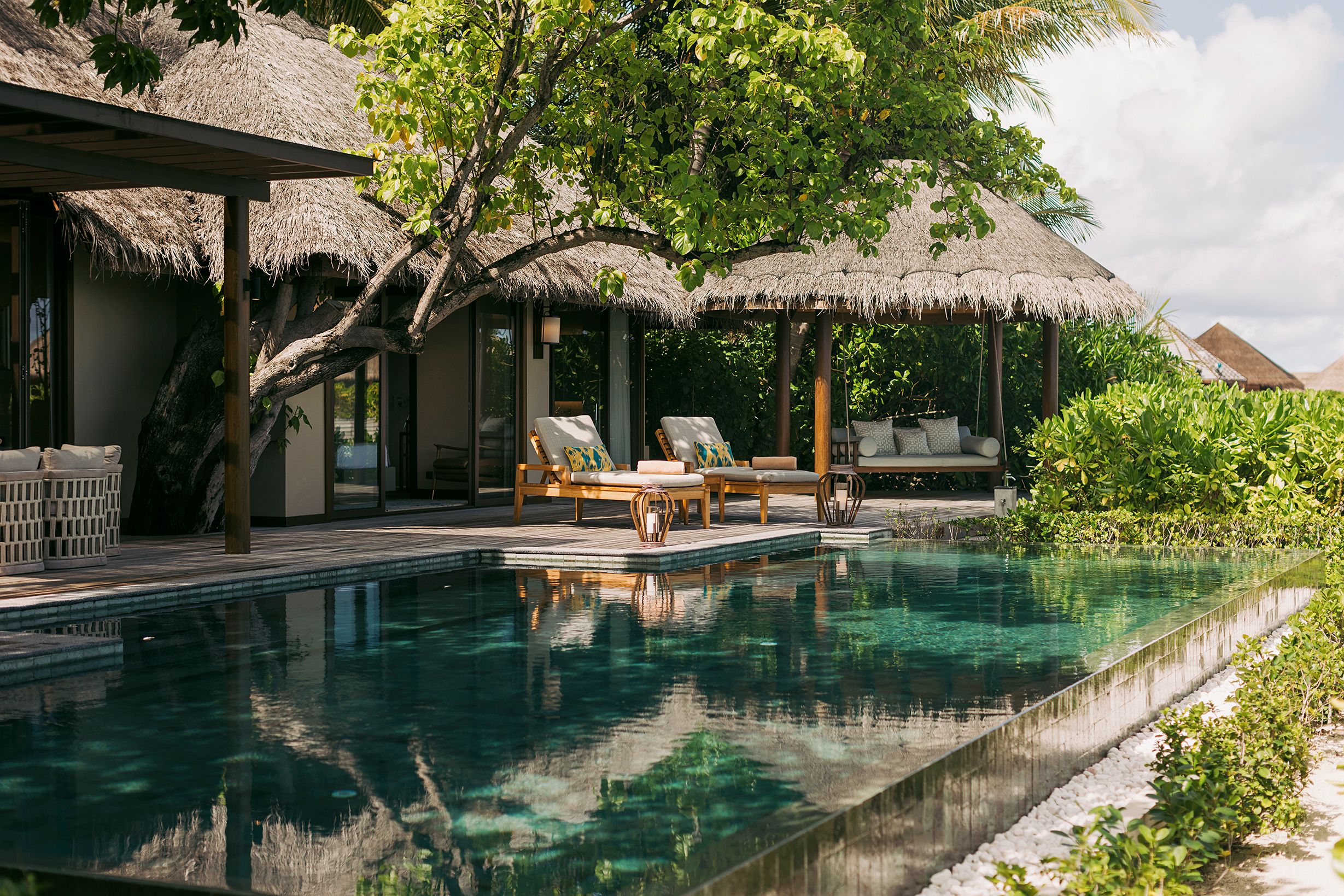 The private pool and thatched pavilions of the Baros Retreat