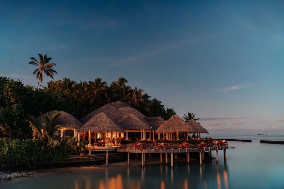 Cayenne Grill lit up at dusk over the water