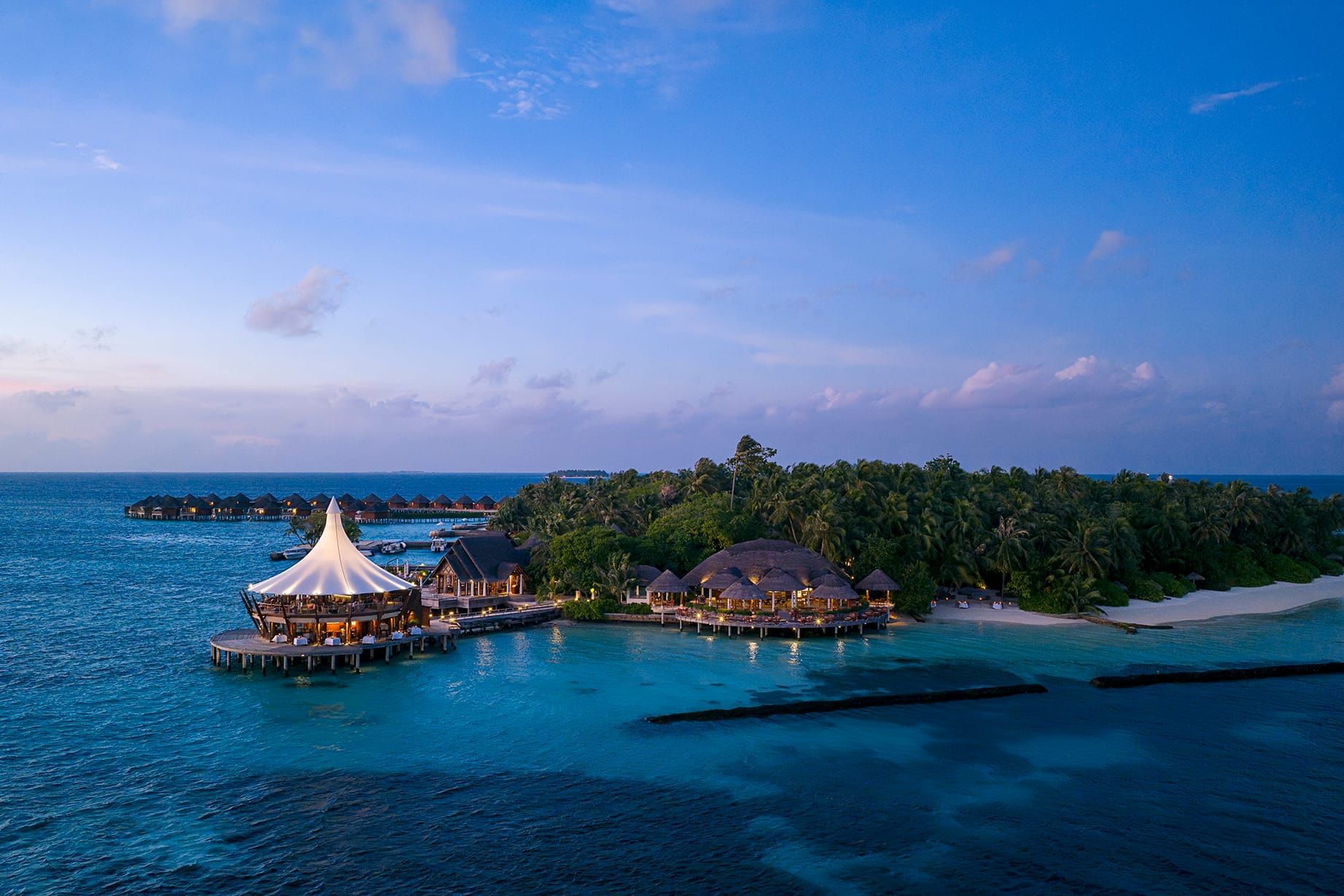 Aerial dusk view of The Lighthouse restaurant on the water beside the island
