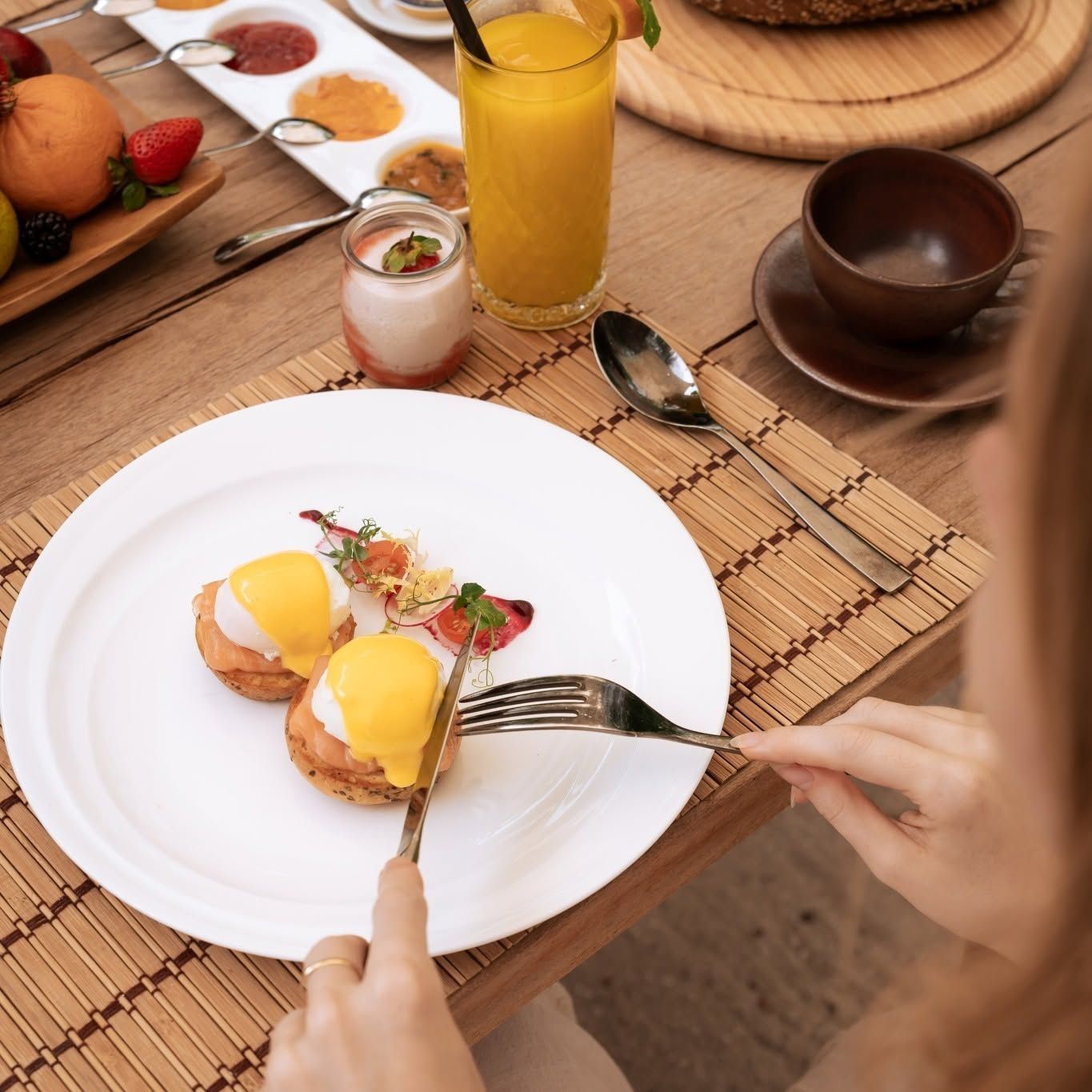 A plate of eggs and a glass of orange juice at the Lime Restaurant breakfast buffet