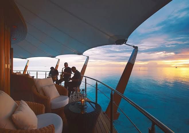 Guests on the deck of The Lighthouse Lounge at sunset
