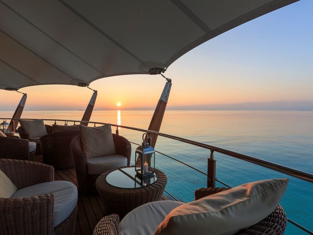 Lounge seating under the canvas roof of The Lighthouse Lounge at sunset