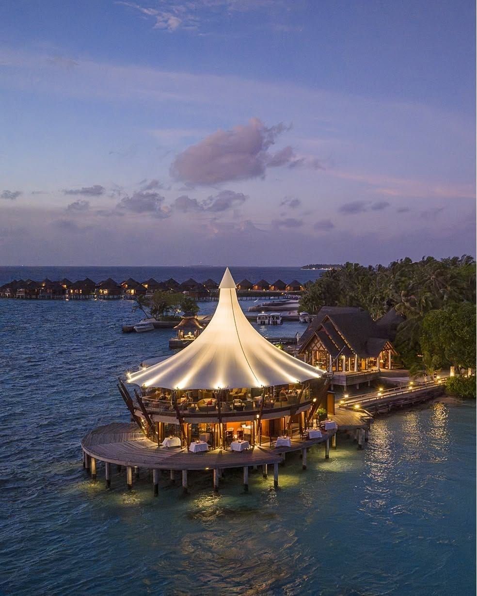 The Lighthouse restaurant illuminated over the water at twilight