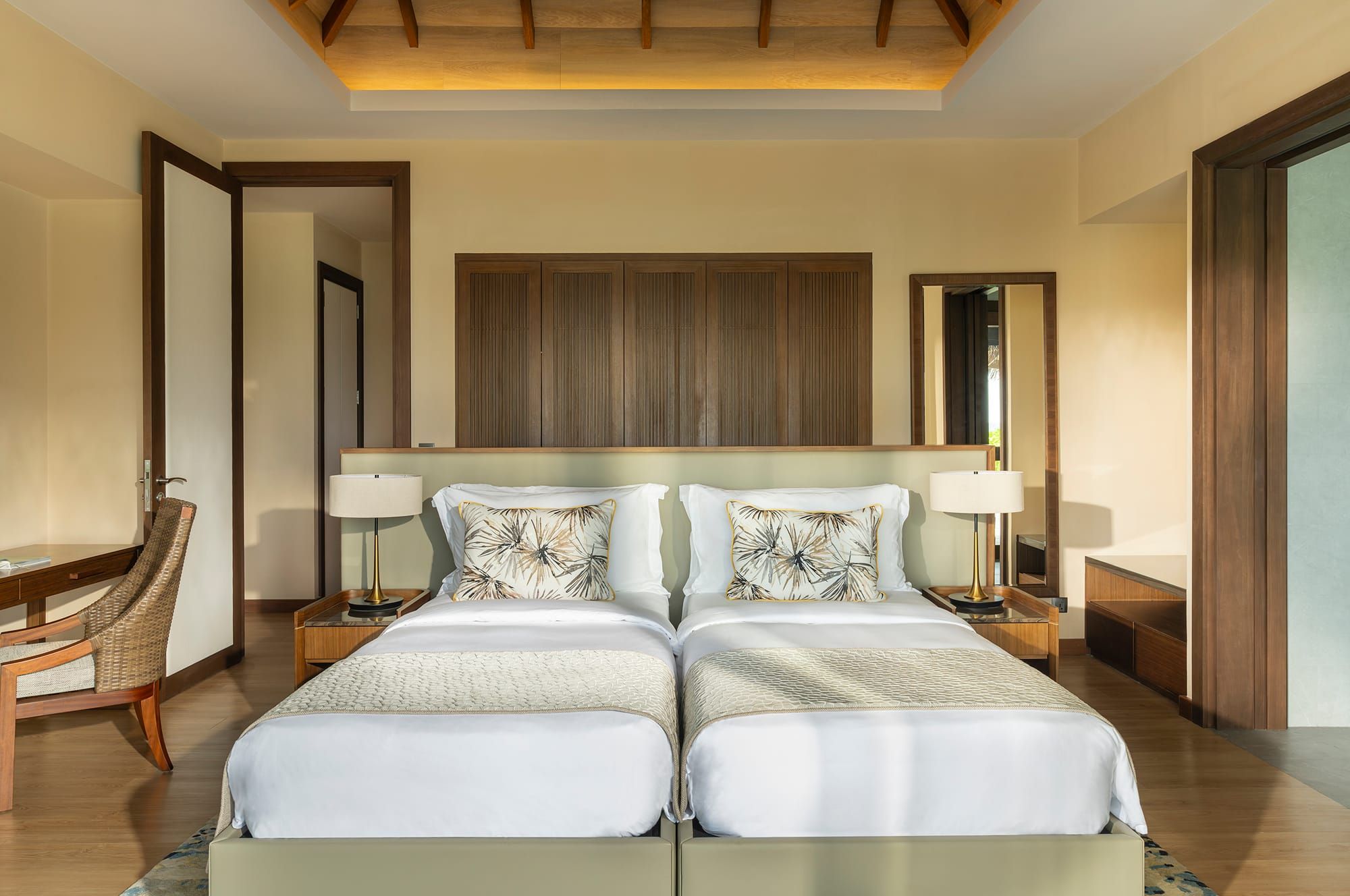 Villa bedroom with two single beds and timber-panelled ceiling