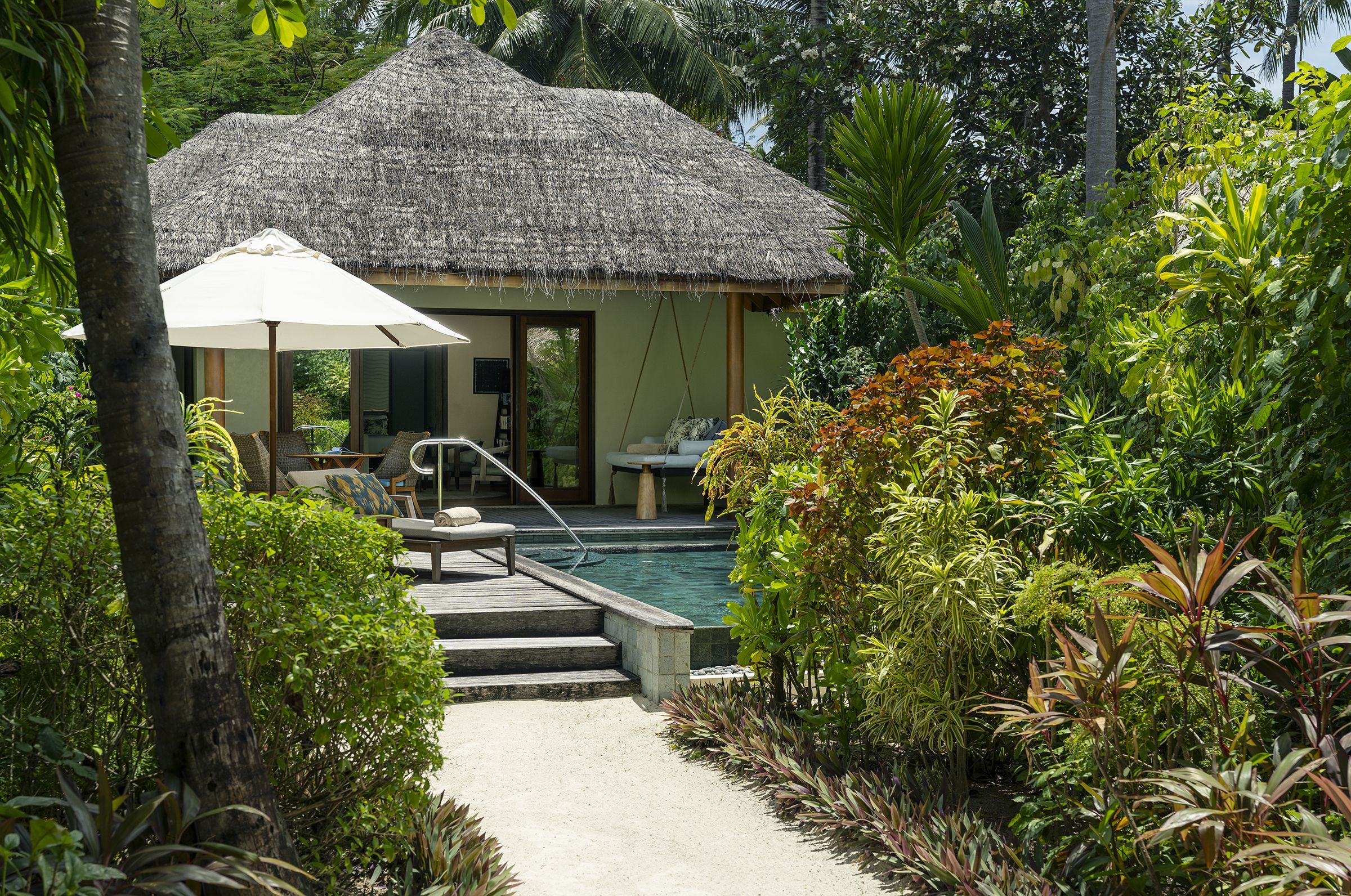 Thatched Baros Residence with its private pool, deck and tropical garden