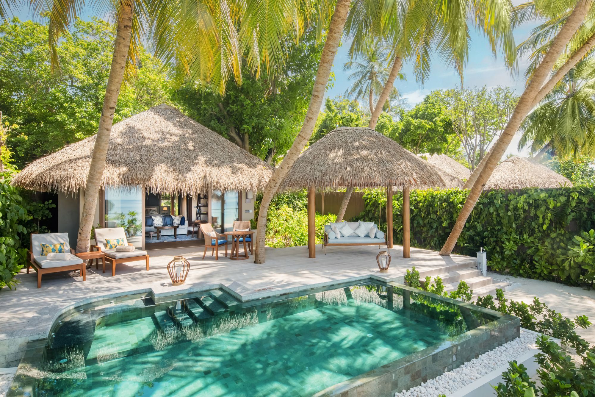 Private pool, deck and thatched gazebos of the Baros Suite, seen from above