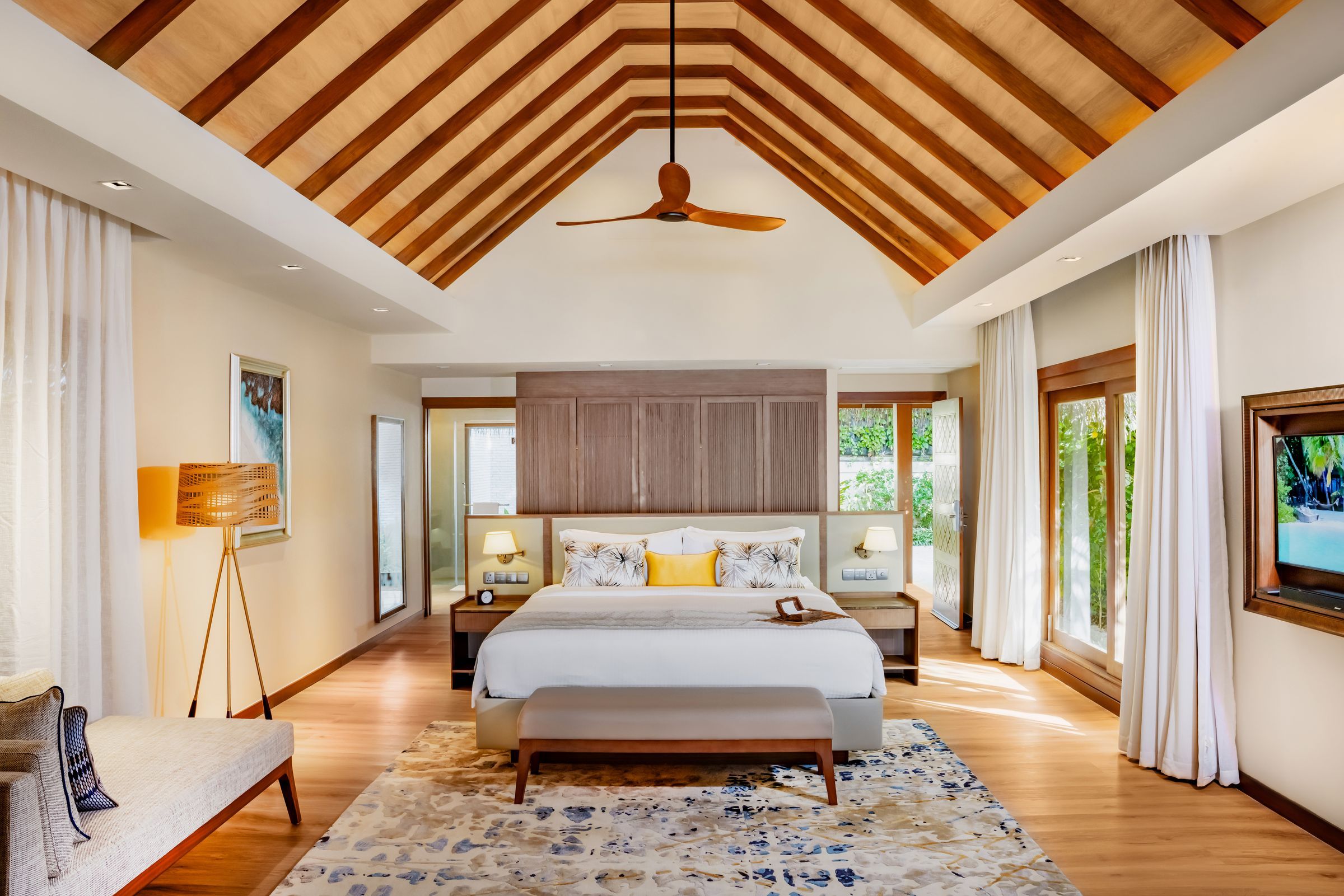 Bedroom of the Baros Suite: a king-size bed under a timber-beamed ceiling