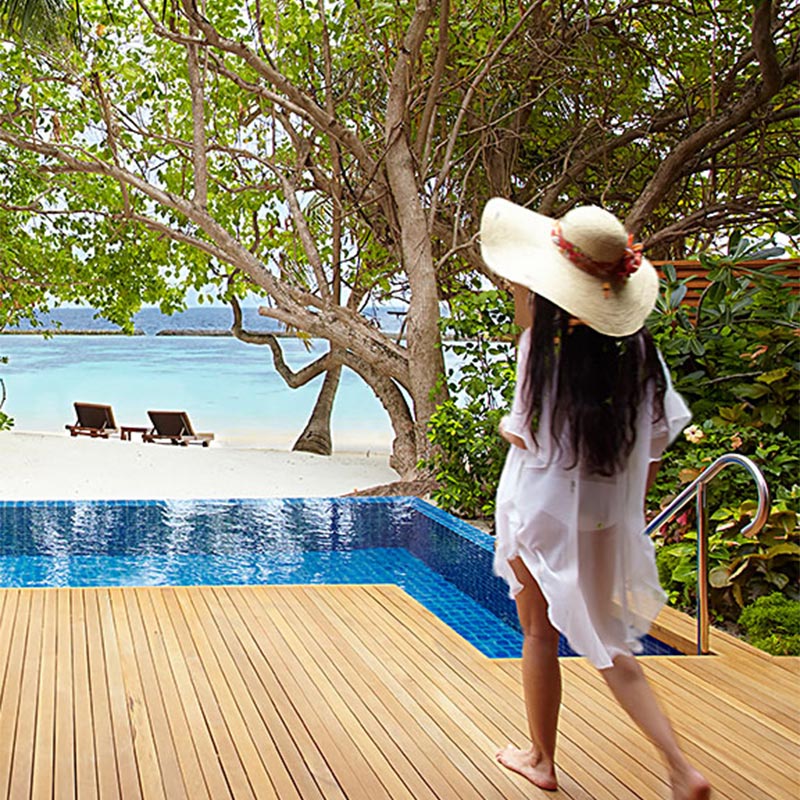 Girl Walking on a Wooden Deck at Baros Maldives 