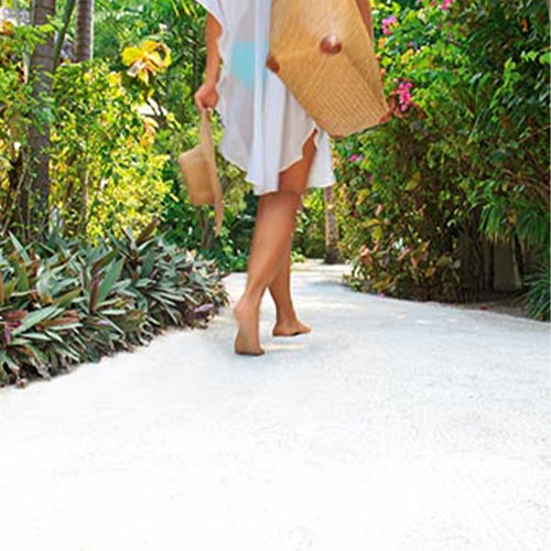 Girl Walking on the Resort Path at Baros Maldives