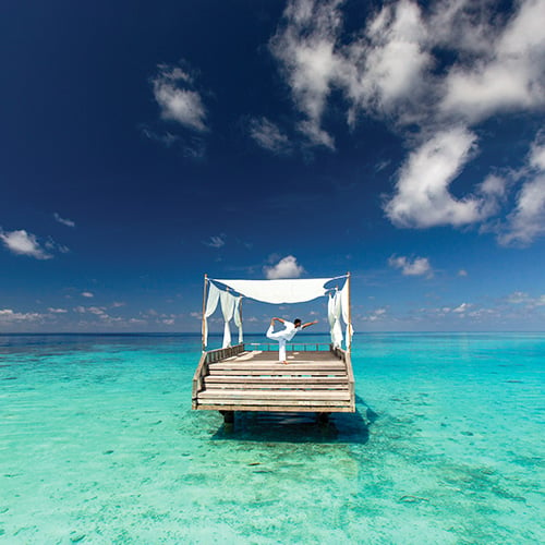 Practicing Yoga Meditation at Baros Maldives