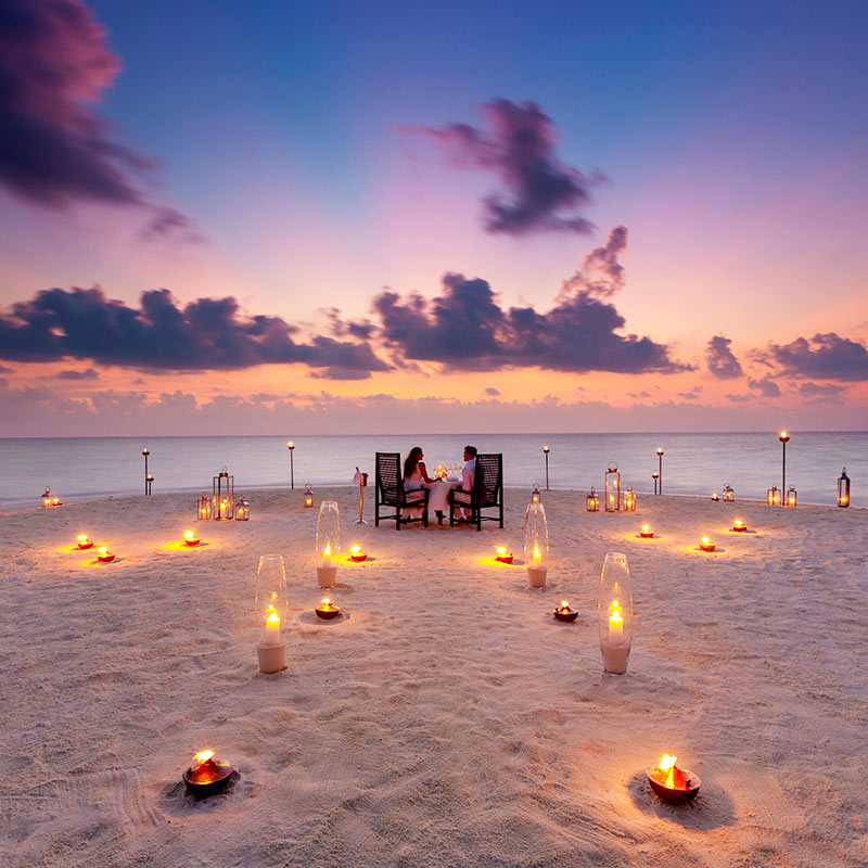 Couple Dining on the Beach at Baros Maldives