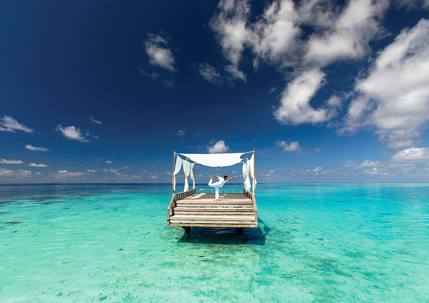 Man Doing Yoga at Baros Maldives