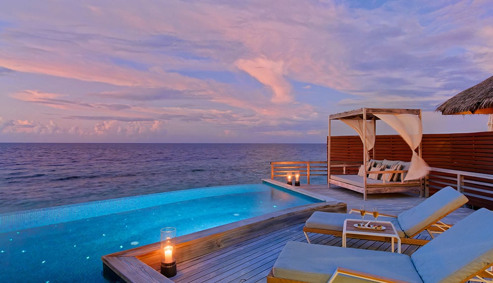 Exterior of a water pool villa during dusk at Baros Maldives 