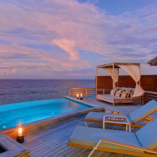 Exterior of a water pool villa during dusk at Baros Maldives 