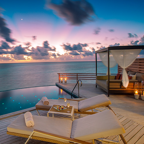 Exterior of a water pool villa during dusk at Baros Maldives 
