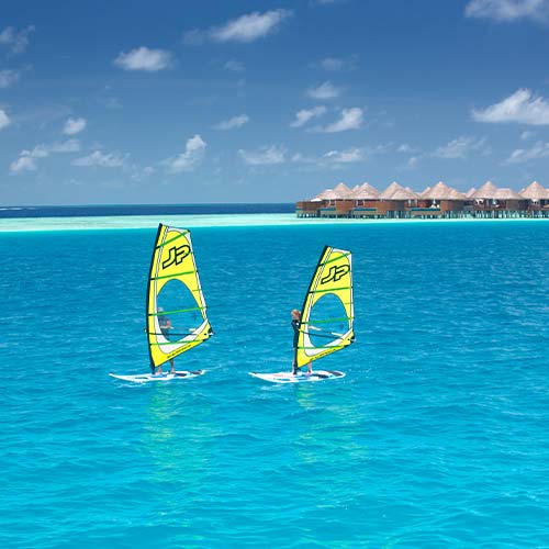 Couple Windsurfing at Baros Maldives