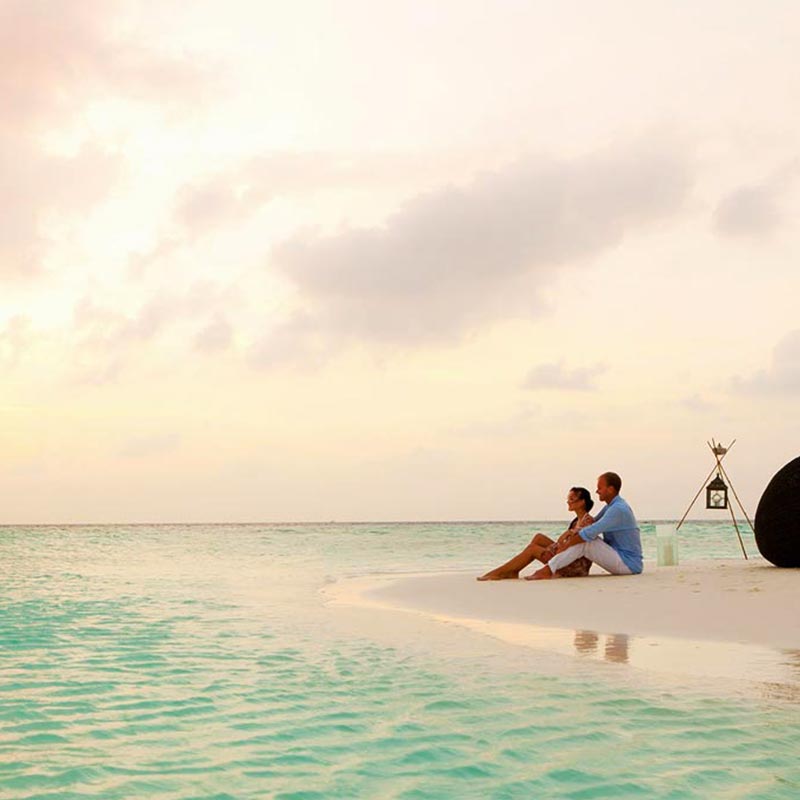 Romantic Couple Sitting on the Beach at Baros 